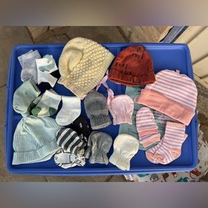 Big bundle of newborn baby socks, mittens, caps, beanies